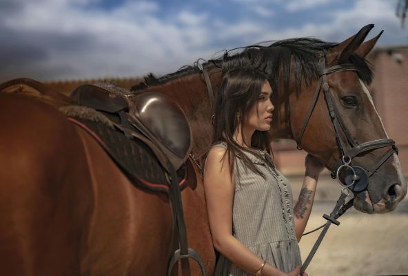 A woman with a horse in rural Qazvin, showcasing equestrian beauty and style.